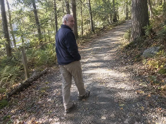 Illustrative everyday activity: a man walking on a woodland trail